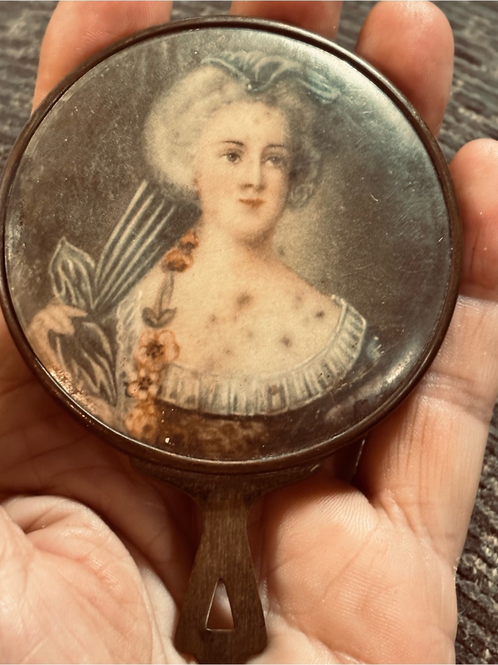Antique hand held mirror with lady